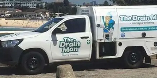 A The Drain Man ute parked near the beach